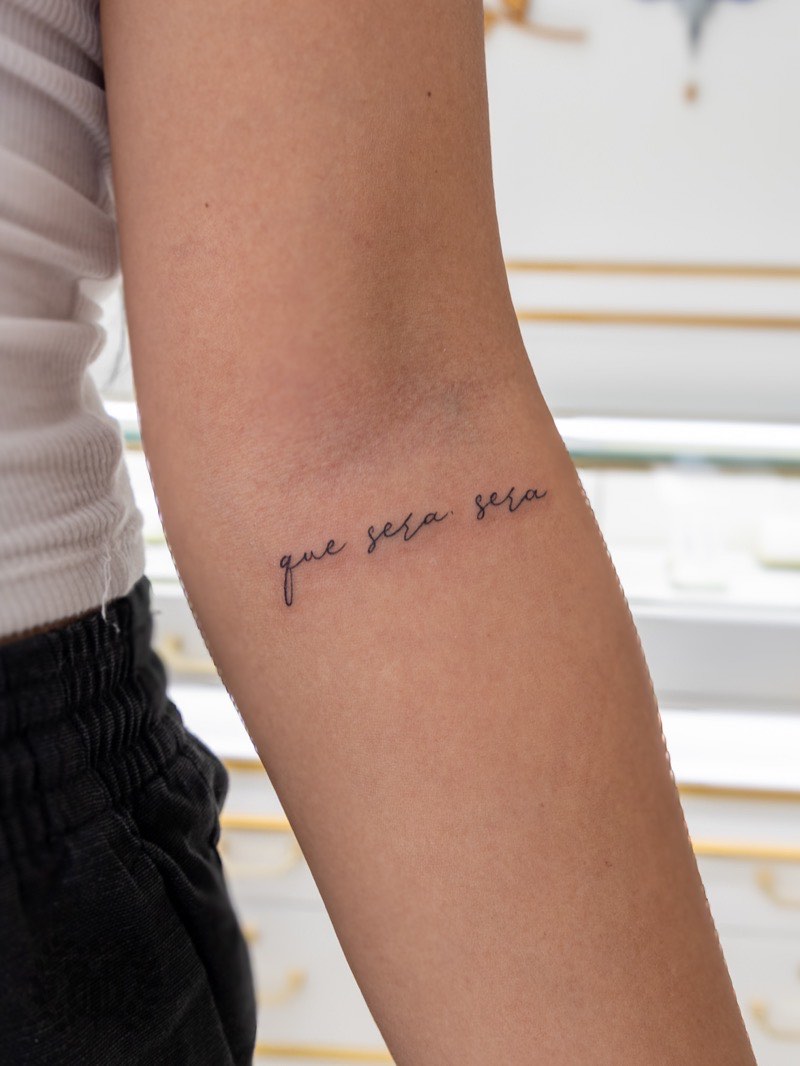 Script tattoo detail — hand-drawn custom lettering