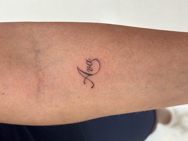 Blackletter tattoo with heavy strokes