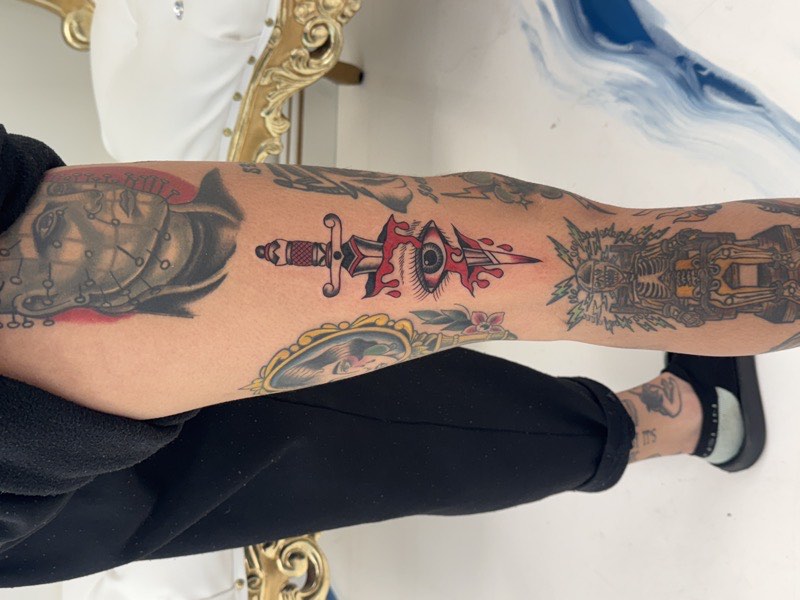 Traditional rose tattoo — bold outline with flat color fill