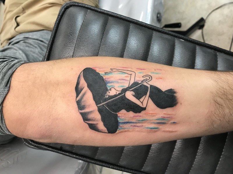 Watercolor feather tattoo — structural spine with color dissolution