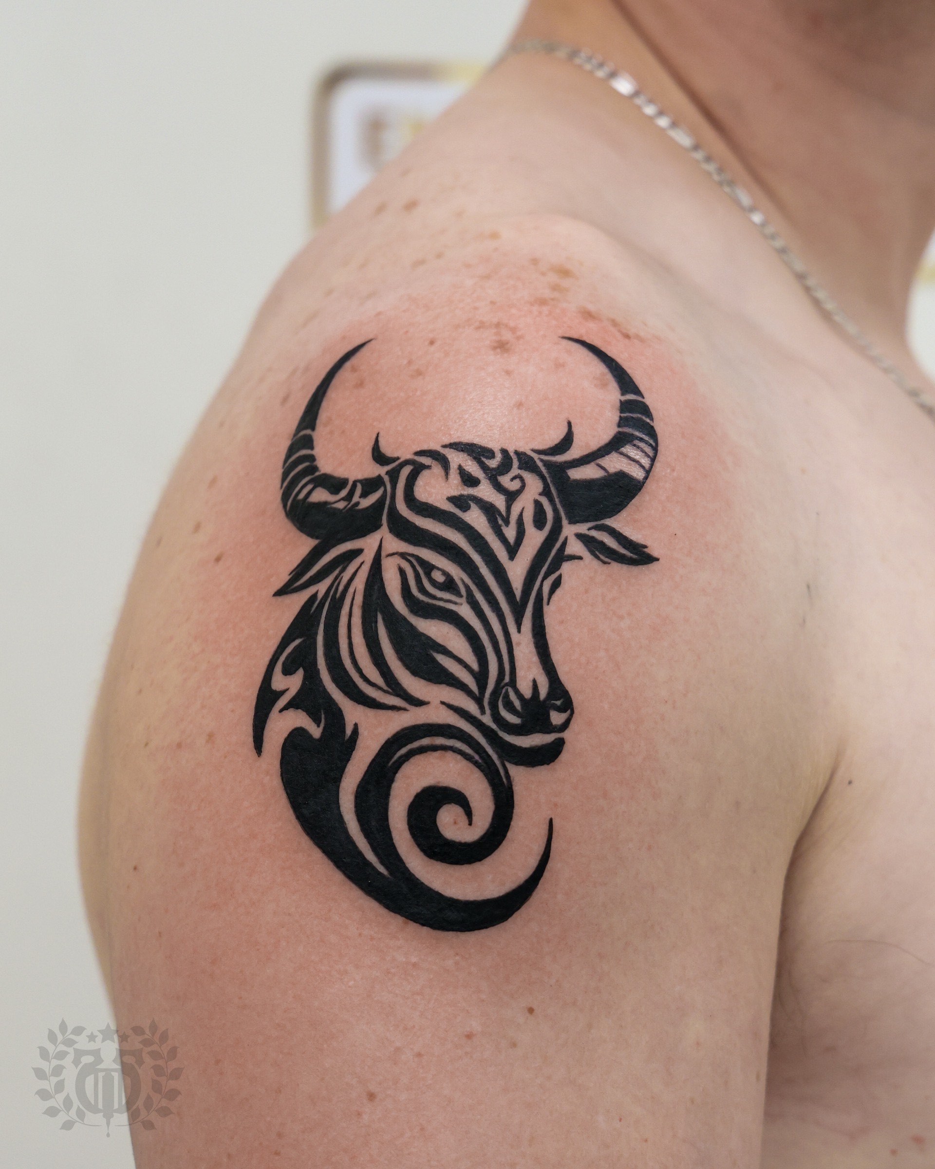 Blackwork tattoo tribal bull head on shoulder in Los Angeles