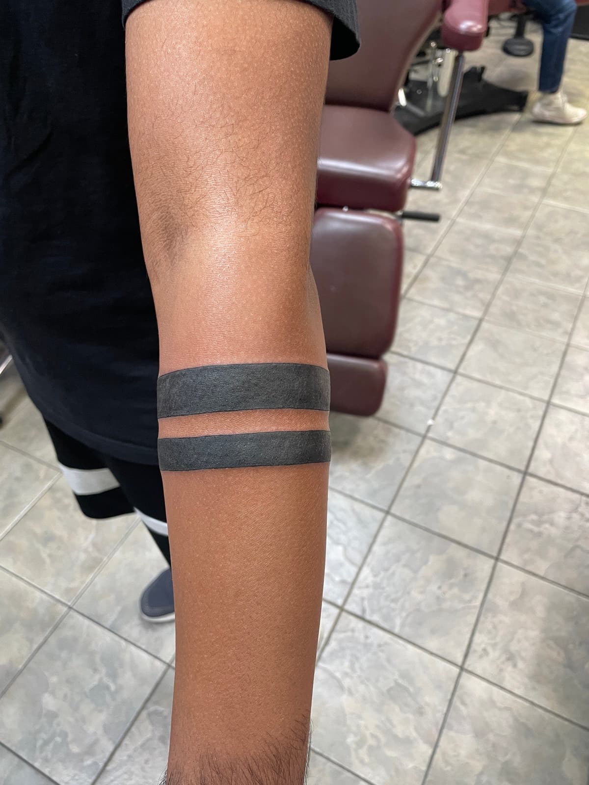 Blackwork tattoo solid black double band armband on forearm in Los Angeles