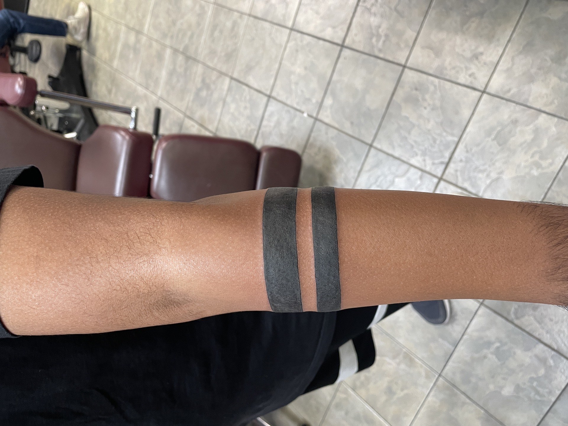Blackwork tattoo solid black double band armband on forearm in Los Angeles
