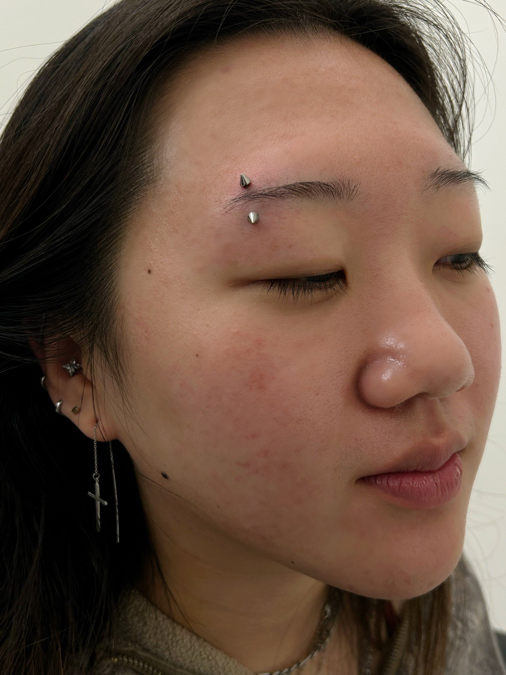 Curved barbell eyebrow piercing with spike ends at Apollo Studio Los Angeles