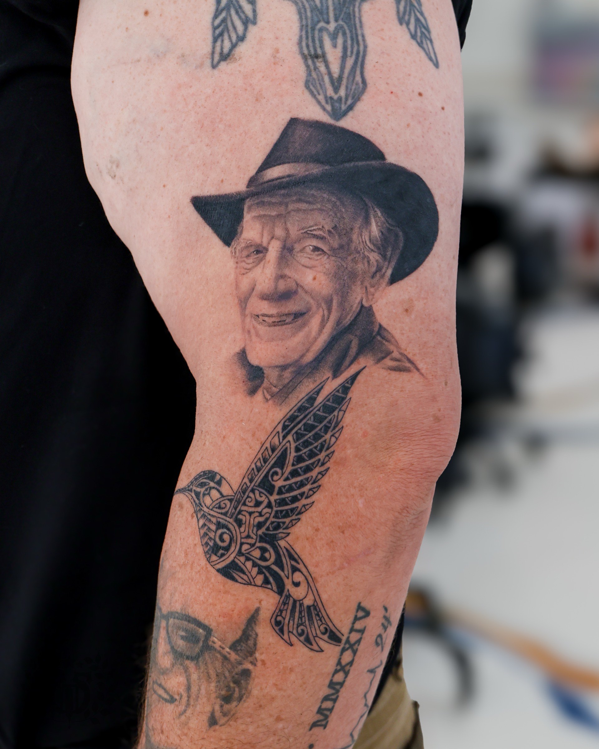 Black and grey portrait of elderly man in cowboy hat realism tattoo in Los Angeles
