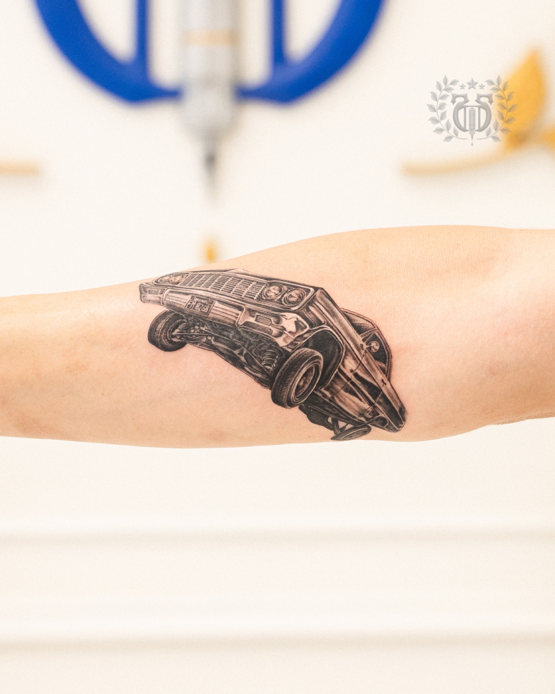 Black and grey realistic classic muscle car realism tattoo on forearm in Los Angeles