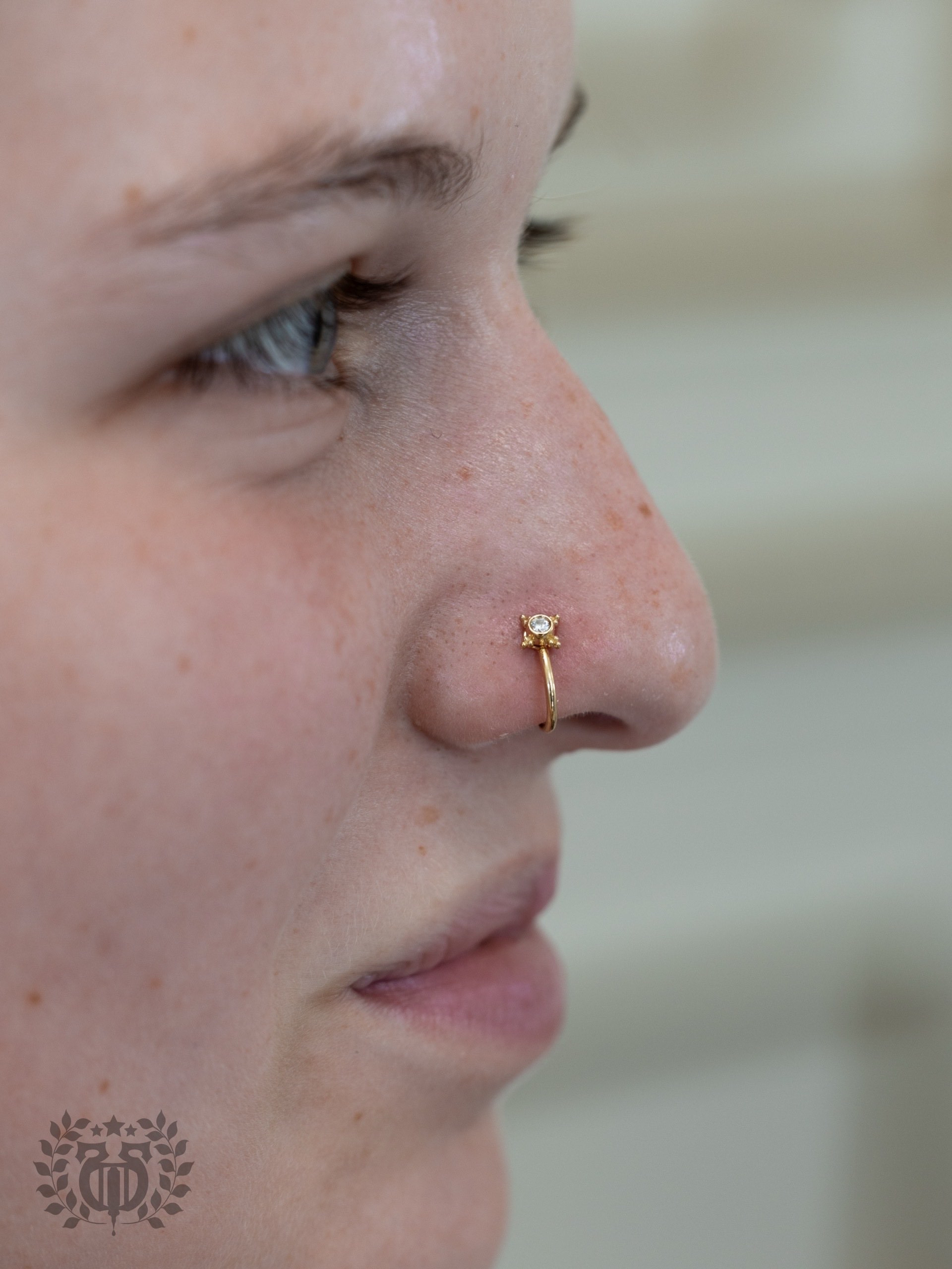 Expert piercer performing tongue piercing procedure at Apollo Studio
