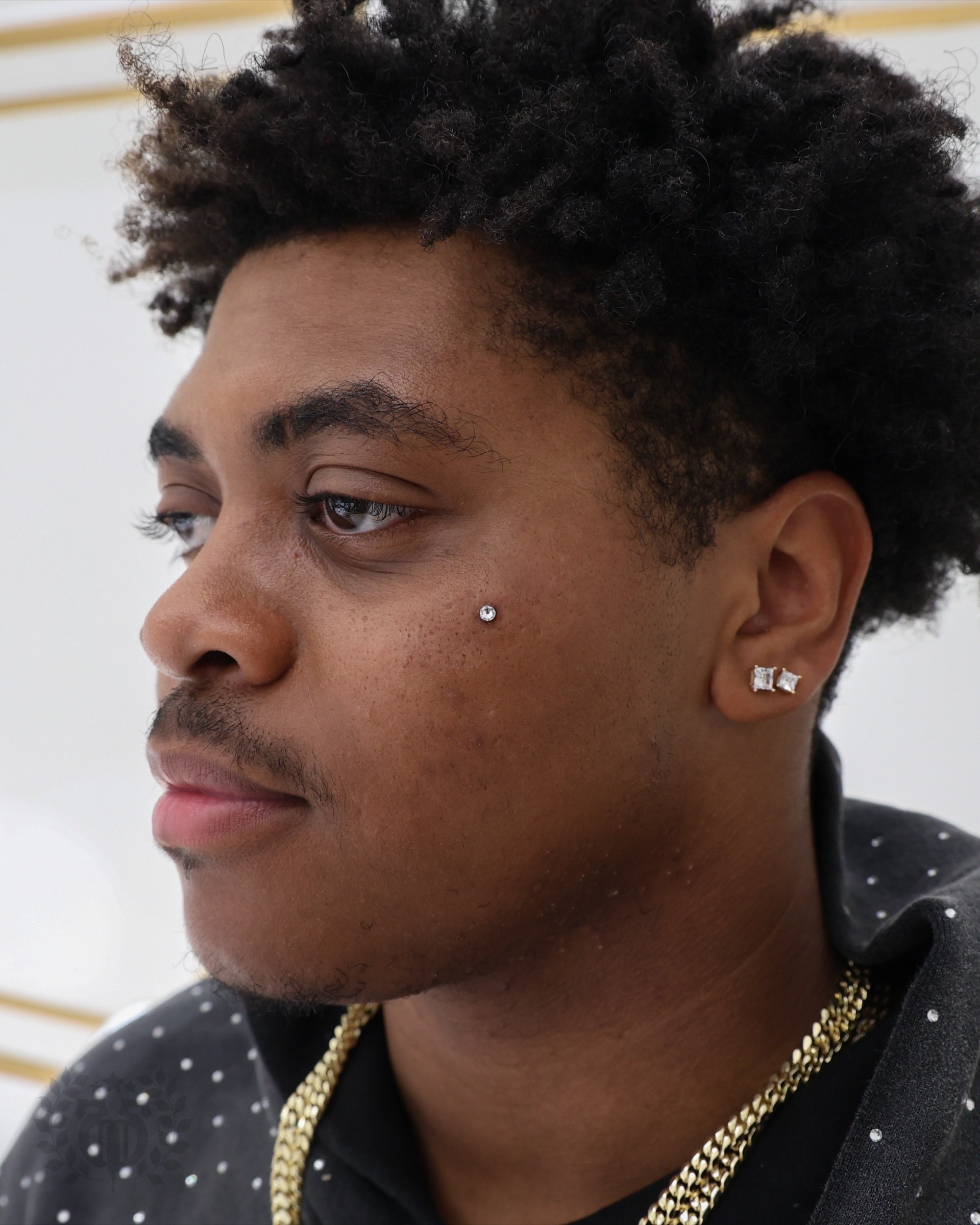 Client receiving smiley piercing at Apollo Tattoo and Piercing Studio