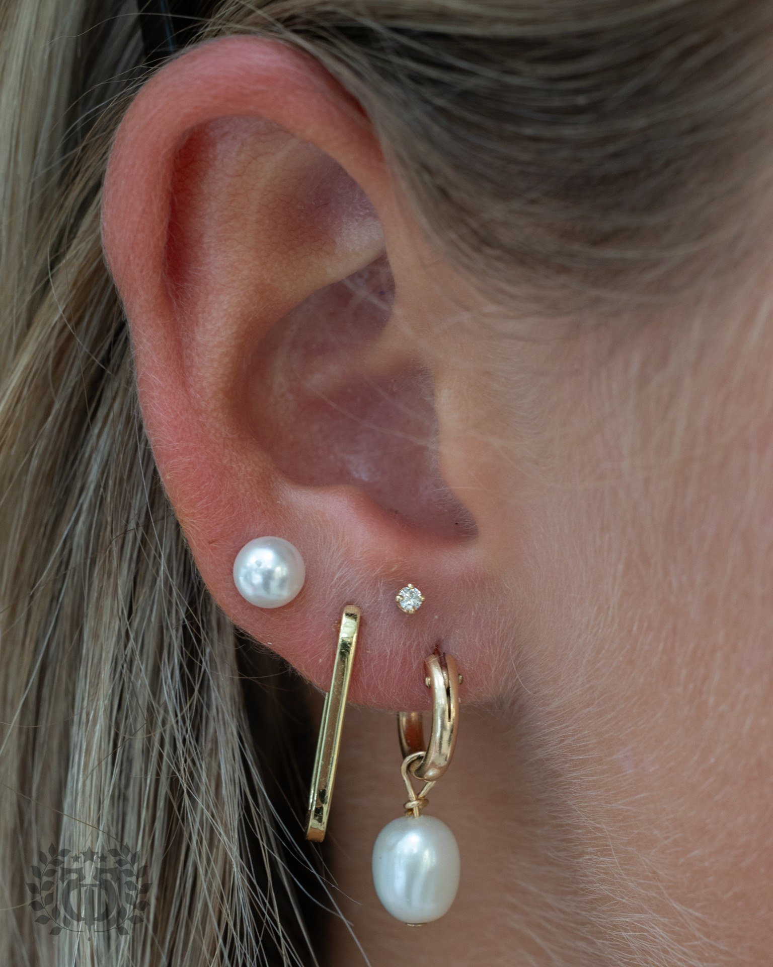 Stacked lobe constellation piercing with pearl at Apollo Studio Los Angeles