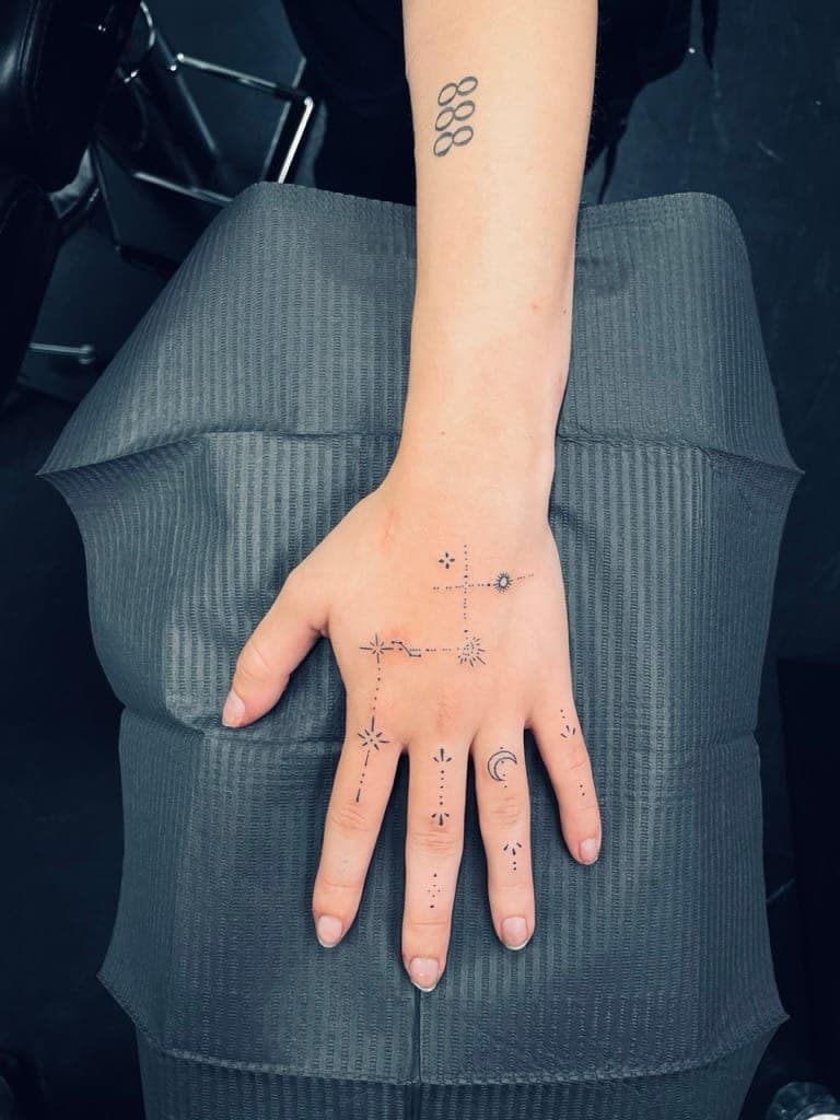 Fine line ornamental hand and finger tattoo at Apollo Studio Los Angeles