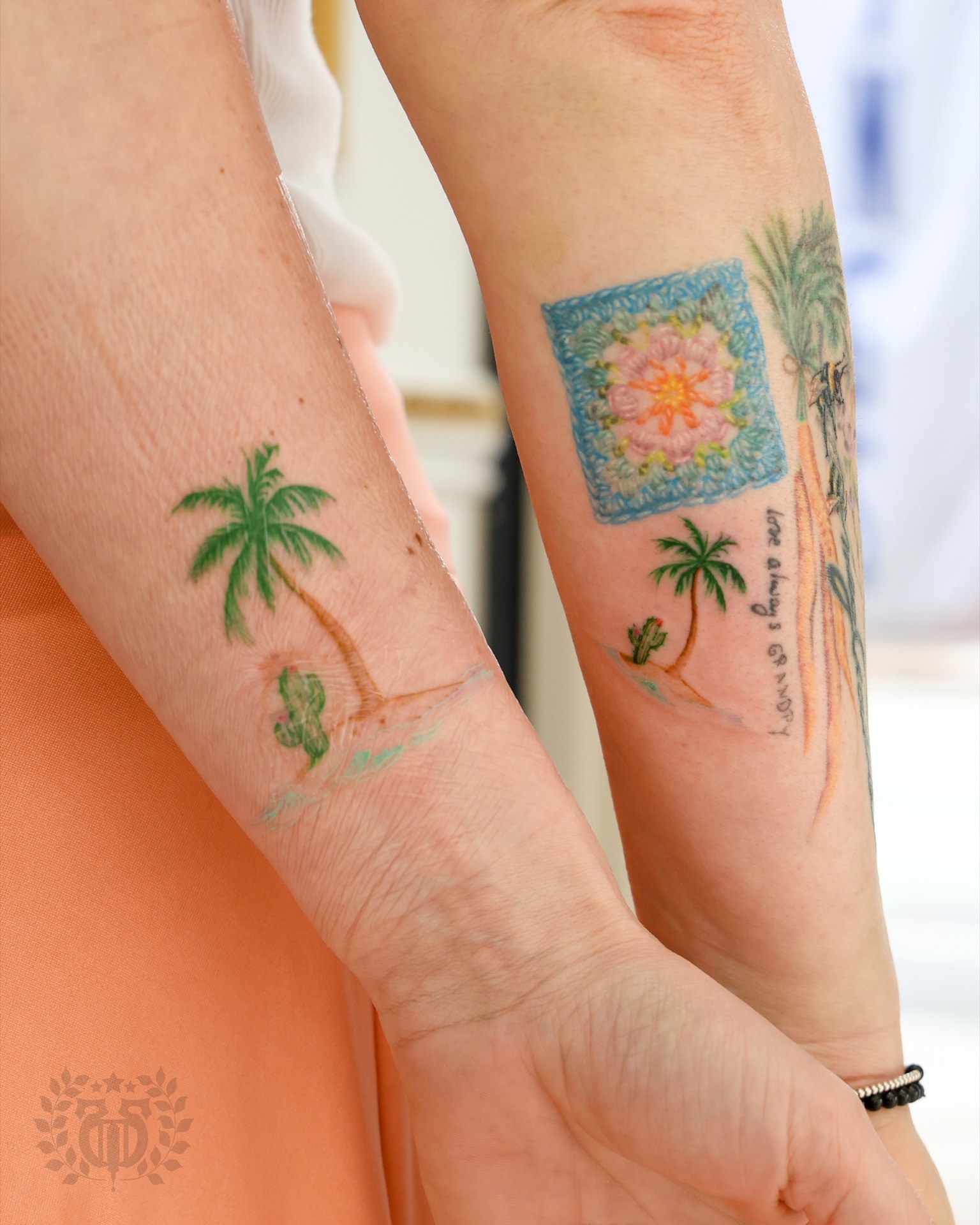 Delicate watercolor palm tree tattoo on the wrist at Apollo Studio Los Angeles