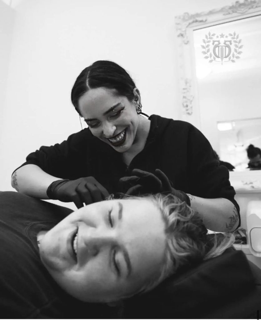 Lead Piercer Bunny collaborates with a client during a gentle freehand piercing session at Apollo Studio.